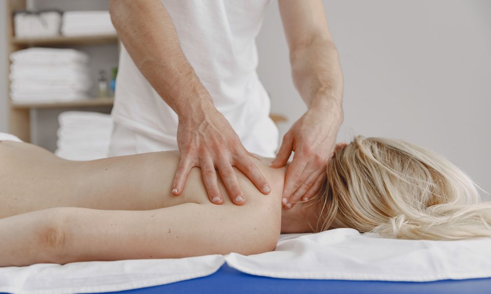 Therapist treating a patient’s neck to relieve headaches