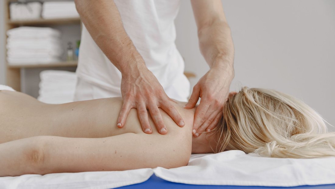 Therapist performing manual soft-tissue treatment